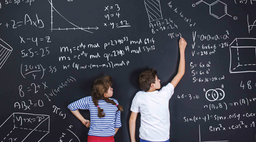 kids writing on chalk board