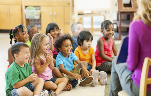 Diverse group of preschoolers listening to a story.