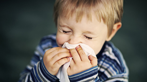 boy blowing nose