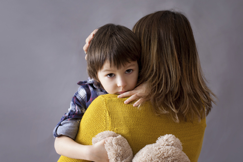 mom holding son in her arms
