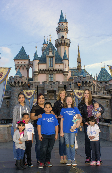 Make-A-Wish recipients in front of Sleeping Beauty Castle at Disneyland