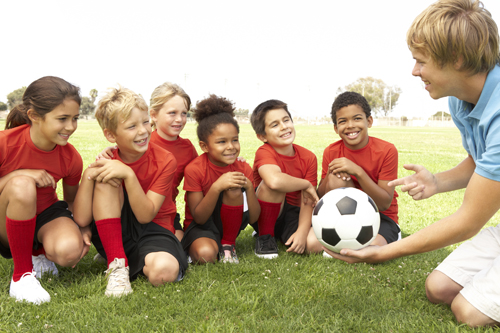 kids talking with soccer coach