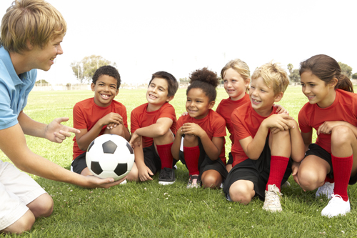 youth soccer team talking with coach