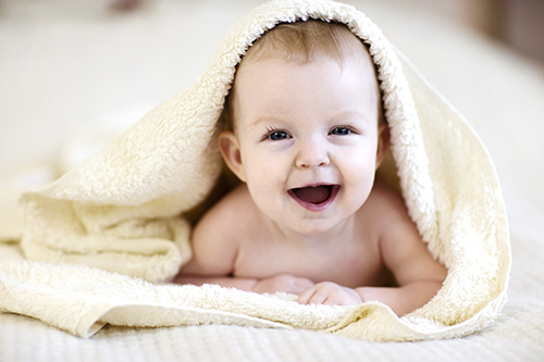 Baby smiling in blanket