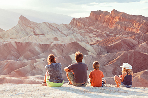 family sitting outside looking at landscape