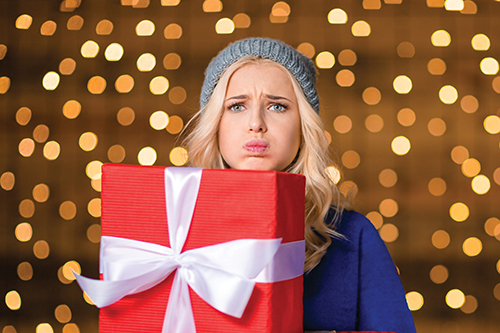 stressed woman holding presents