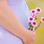 pregnant belly flower wellness