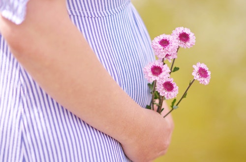 pregnant belly flower wellness
