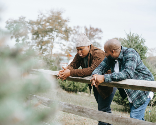 Father and son talking outside.