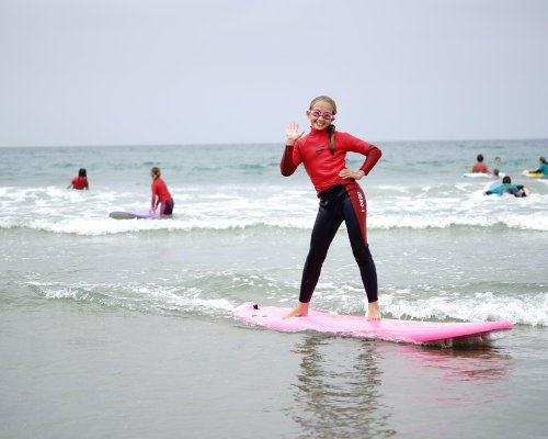 Endless Sun Surf Camp girl surfing at Newport Beach Pier
