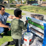 YMCA mentor and child painting bench