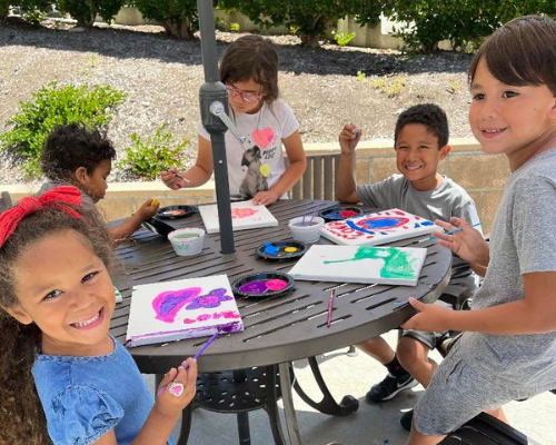 YMCA Kids Painting at a table