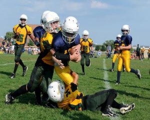 Teens playing football unsplash