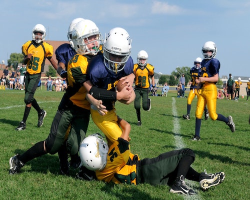 Teens playing football unsplash