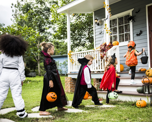 Kids lined up in costumes to go Trick or Treating