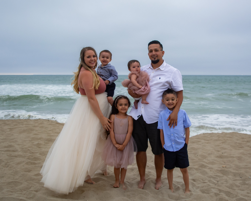 Courtney Brown with her family on the beach with ocean background