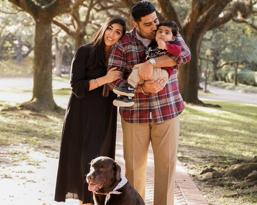Mirchandani Family Photo with brown pet dog and tree background 