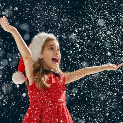 Girl enjoying falling snow.