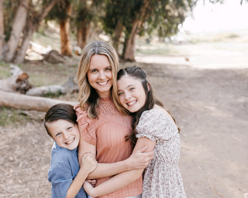 Vanessa Knowles with her two kids in a tree background 