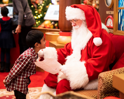 kid giving Santa his Christmas list