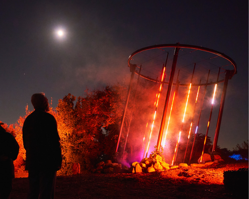 Guy looking at light structure at Astra Lumina Los Angeles