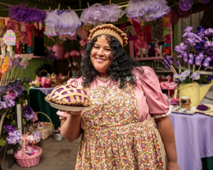 smiling lady holding boysenberry pie at Knott’s Boysenberry Festival
