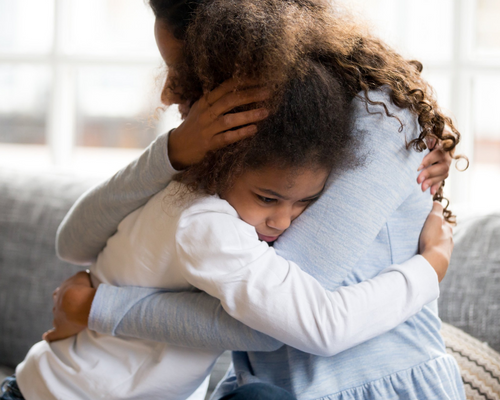 a mother and daughter hugging each other