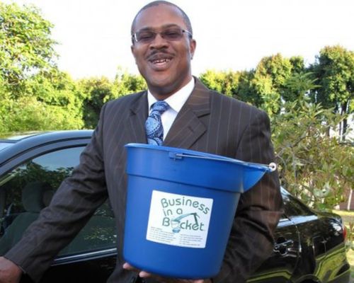  Kevin Jones, founder of Business in a Bucket Institute, holding a bucket.