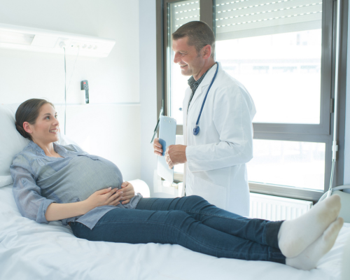 pregnant mom talking a doctor