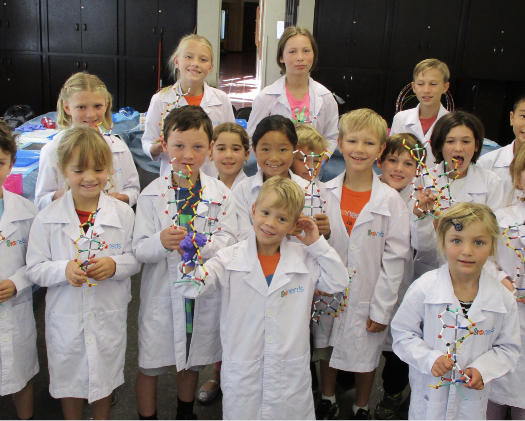 Students holding up their science projects at Bionerds Best Science Tech Camp