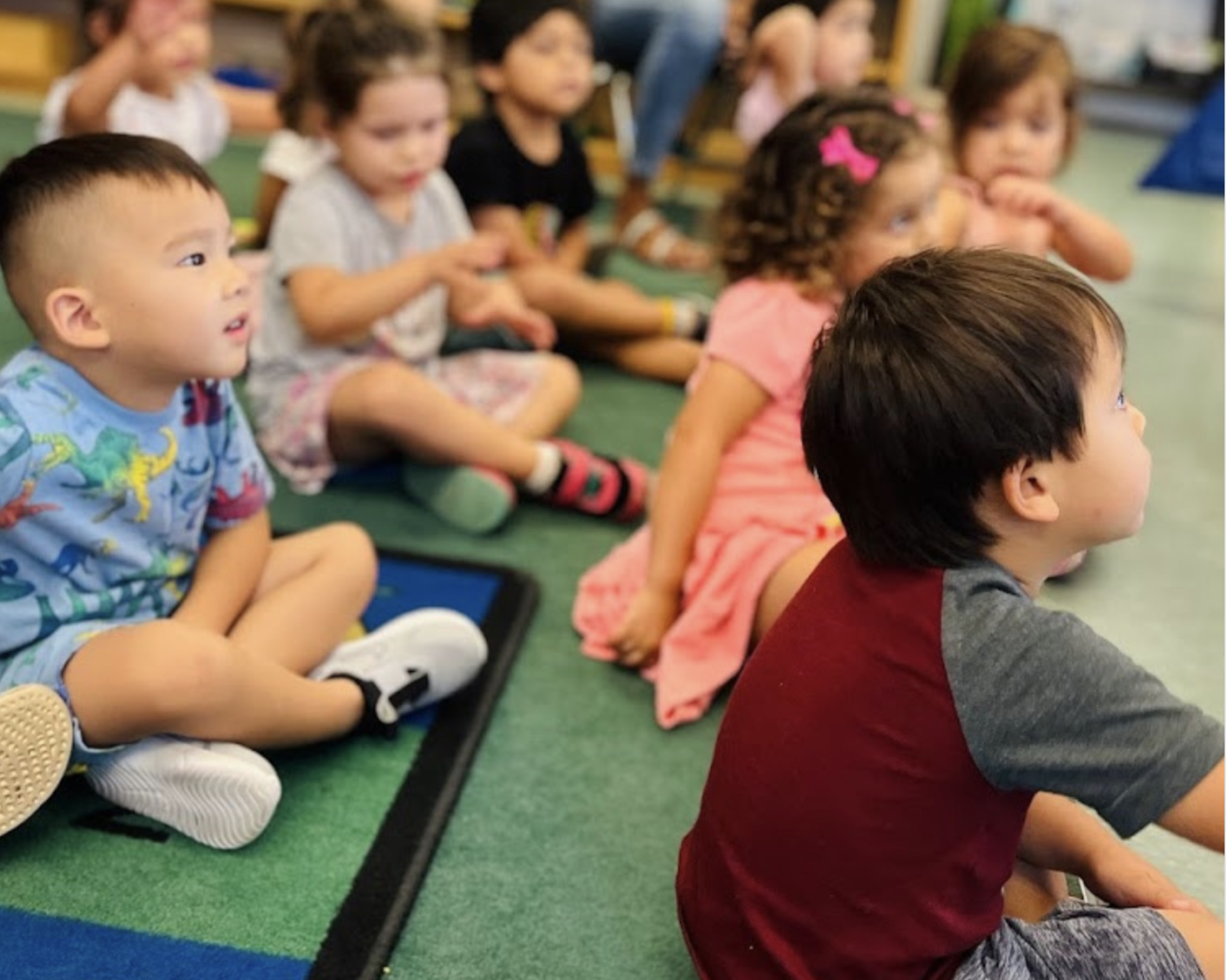 Children gathered on a rug at Little Scholars Academy Best Montessori School