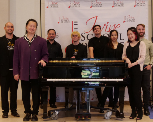 Musicians posing in front of a piano at the Irvine School of Music Best Music Lessons