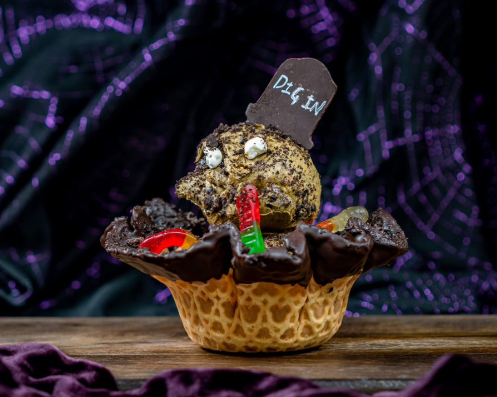Rest in Chocolate Sundae with gummy worms and marshmallows in a waffle cone bowl