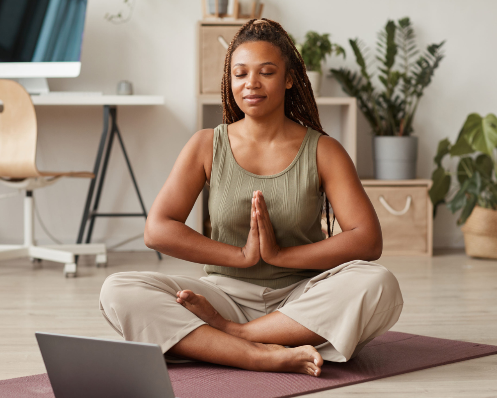 Young woman meditating at work
