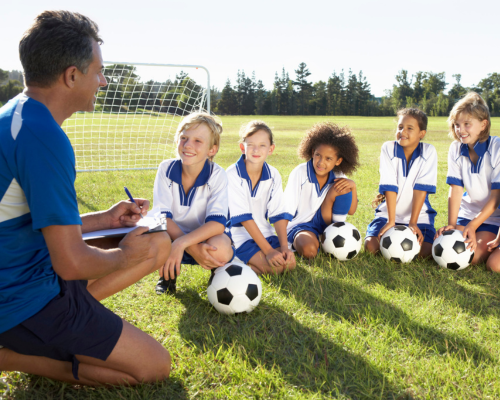 kid soccer team listening to a coach