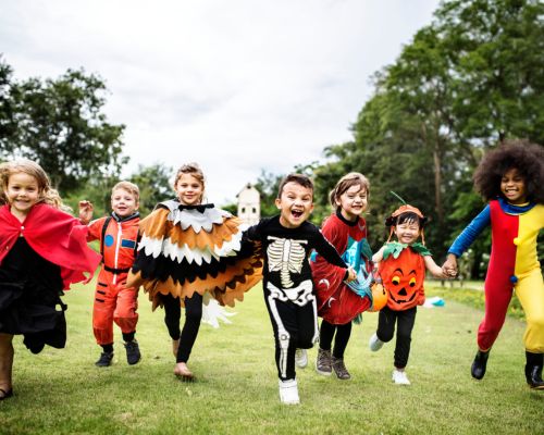 kids running in halloween costumes